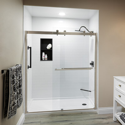 Bath Concepts Denali barn-style sliding glass shower door with brushed nickel hardware and clear glass